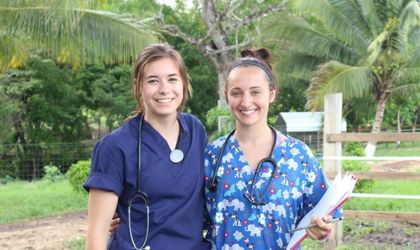 Two nursing students in blue scrubs