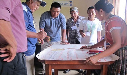 Men discussing on Maya land rights