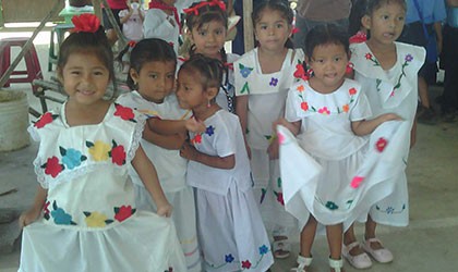 Young children in their white printed with flower dress