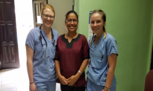 Two nursing students with a community health nurse in Belize
